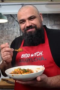 Chris tasting a flexed dish with a spoon