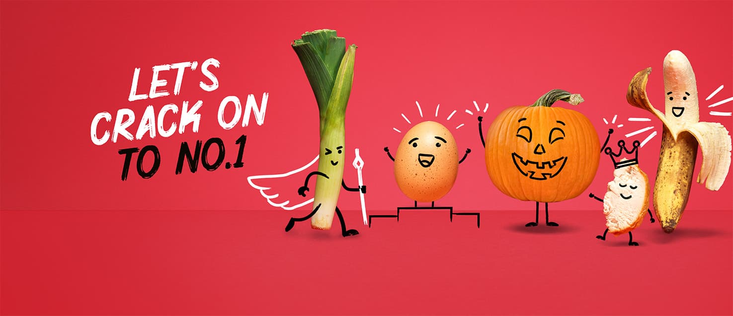 A line up of cute food characters with happy faces (a leek, egg, pumpkin, chicken and banana) with the headline: Let's Crack on to No. 1.