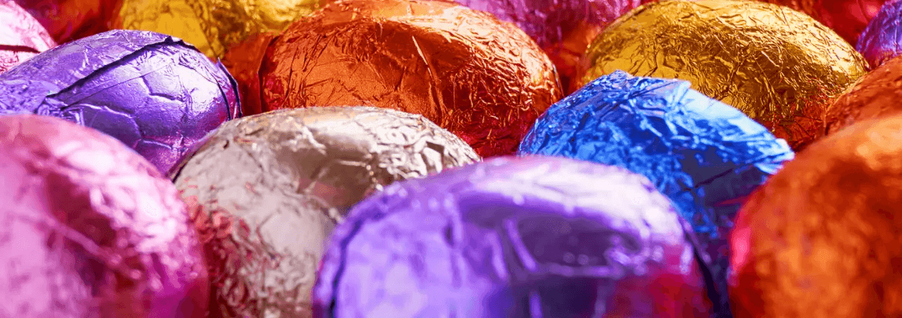 Multicoloured Easter Eggs wrapped in foil.