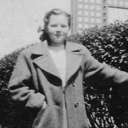 Melba, a 12 year old from the 1950s, smiles at the camera.