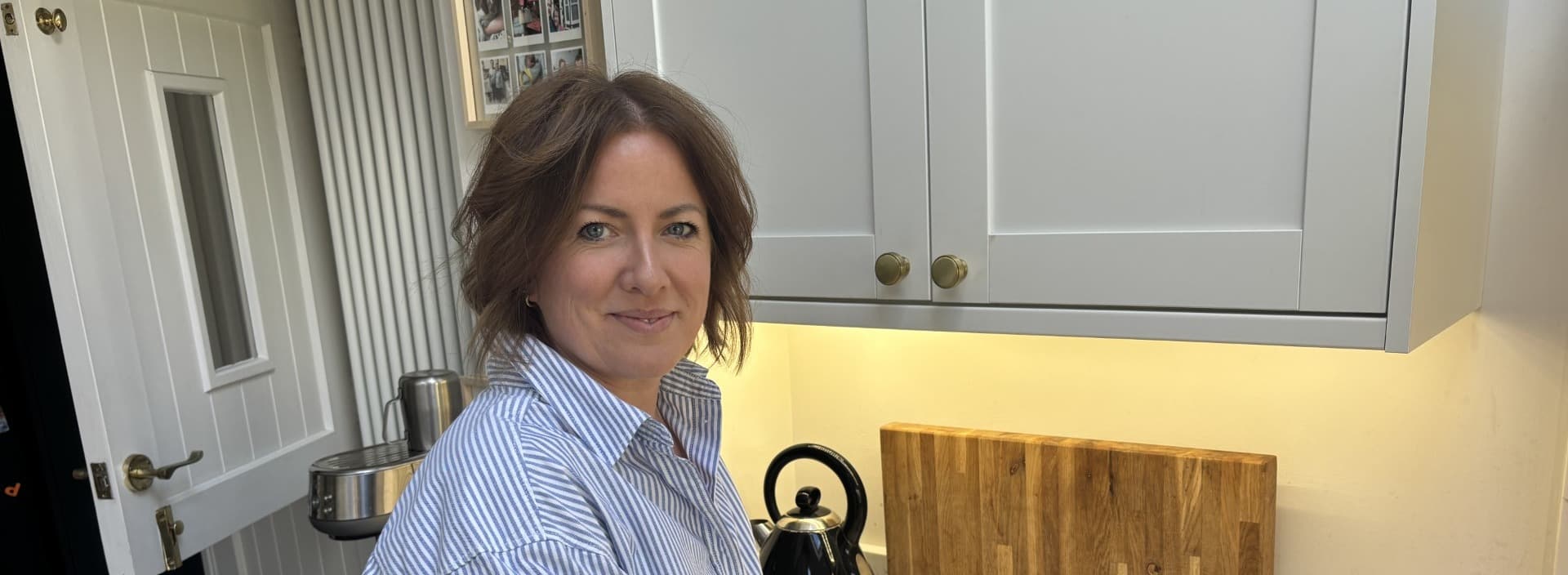 Sian Morgan, Food Waste Specialist, stands in her kitchen making a pizza.